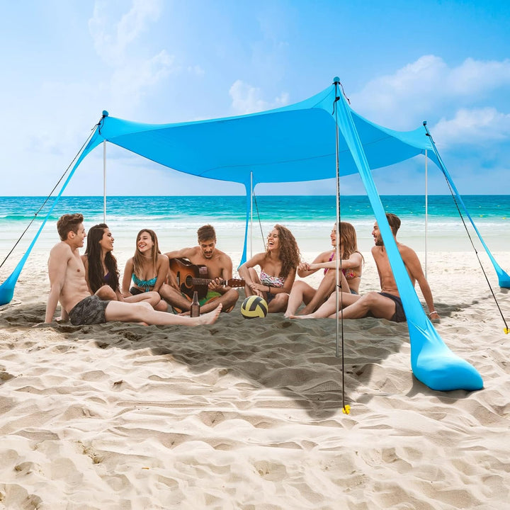 Tienda de playa familiar con polos de aluminio y anclajes de arena